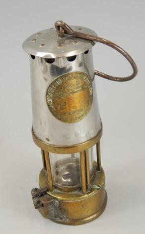 A brass and polished steel miner's lamp