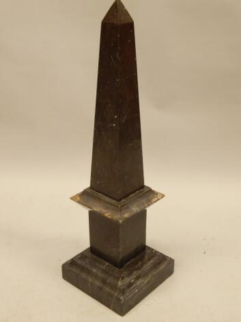 A modern grey variegated marble obelisk