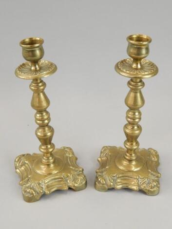 A pair of 19thC cast brass candlesticks