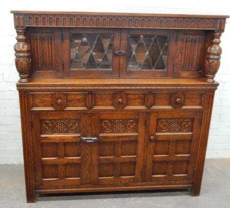 A reproduction oak court cupboard in Old Charm style