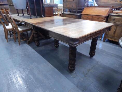 A Victorian oak extending dining table