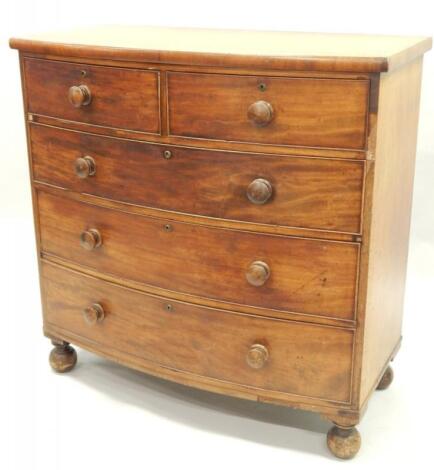 A Victorian mahogany bow fronted chest of two short and three long drawers