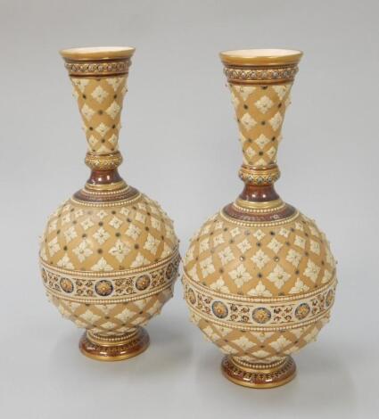 A pair of Mettlach stoneware bottle shaped vases