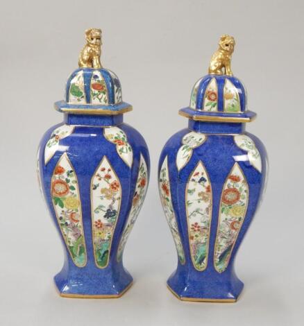 A pair of Phoenix ware pottery vases and covers