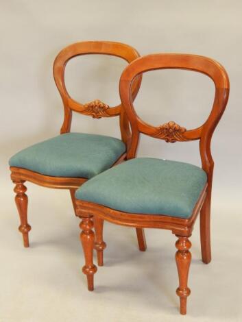 A pair of Victorian balloon back dining chairs