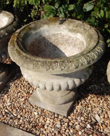 Seven composition part fluted garden urns