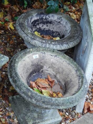 Two similar composition garden urns.