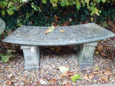 A composition crescent shaped garden seat