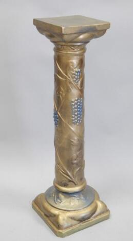 A gold painted pedestal