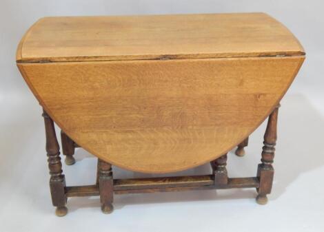 An oak oval drop leaf table