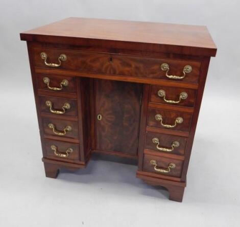 A figured mahogany and kneehole desk