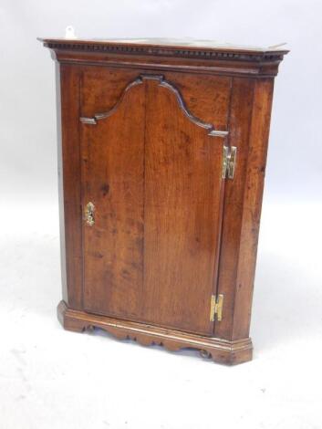 An 18thC oak corner cabinet