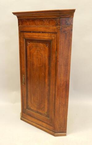 An early 19thC mahogany chequer banded and boxwood strung corner cabinet