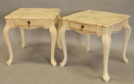 A pair of modern cream lacquered lamp tables