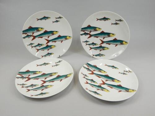 A set of four Fornasetti designed porcelain plates