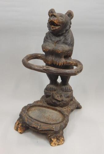 A late 19th-early 20thC Black Forest linden wood carved umbrella stand