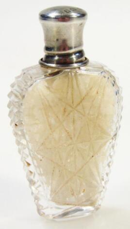 An early 20thC cut glass and silver topped perfume bottle