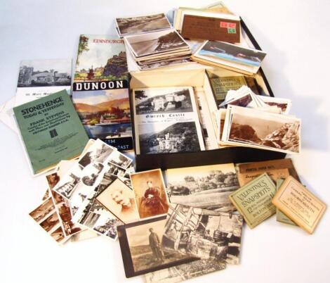 A box containing a quantity of postcards and associated ephemera