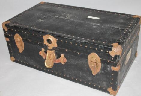 A 20thC metal bound and pressed material and leather trunk