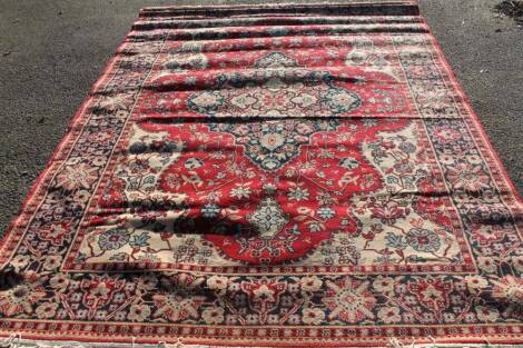 A 20thC machine woven rug