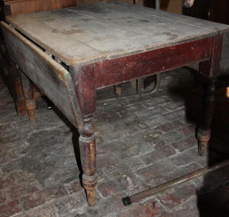 A 19thC stripped pine plank top drop leaf table