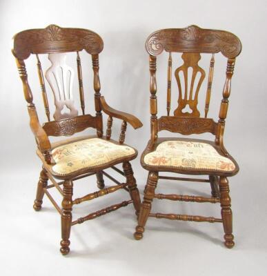 A set of eight oak dining chairs with carved crest rails