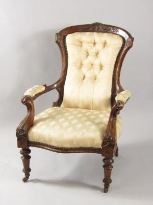 A Victorian mahogany armchair with carved crest rail