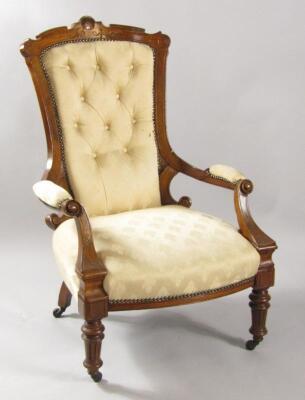 A Victorian mahogany armchair with carved crest rail