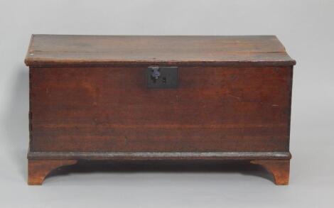 An 18thC oak coffer raised on bracket feet