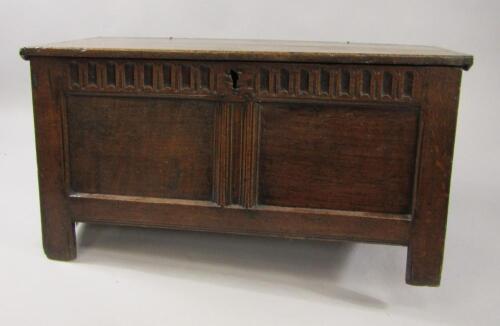 A 17thC oak coffer with a carved panel front