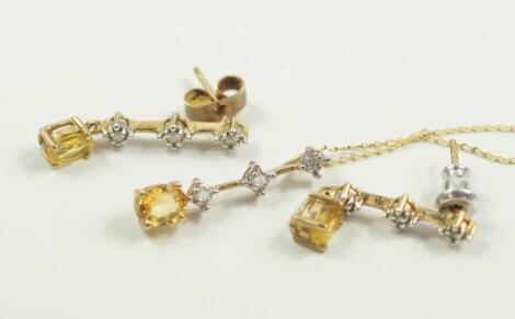 A yellow metal citrine and diamond pendant on chain