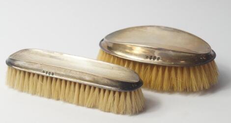 A George V silver backed hair and clothes brush set