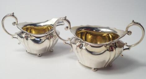 An Edward VIII semi fluted silver cream jug and sugar bowl