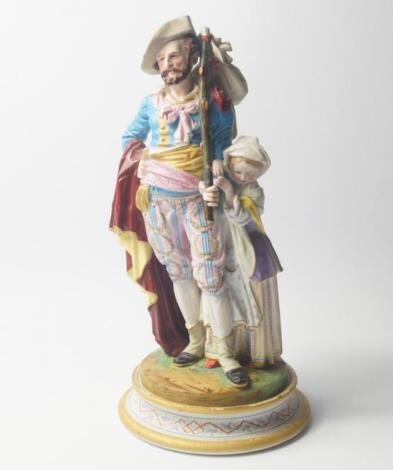 A French late 19thC bisque porcelain figure group of a traveller and his daughter