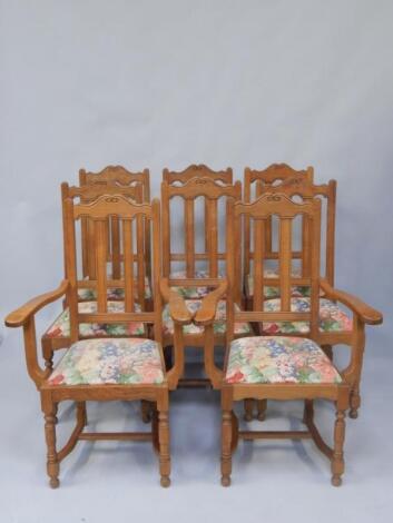 A set of twelve oak dining chairs