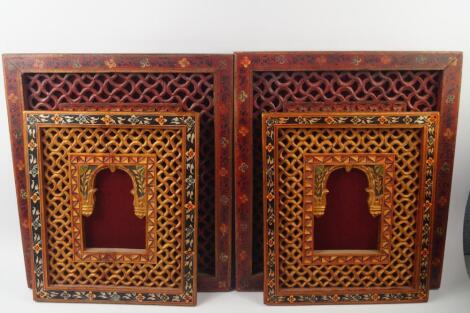 A pair of Indian carved and painted window panels