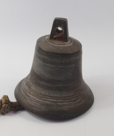 A brass ship's bell with an ornately knotted rope pull clanger