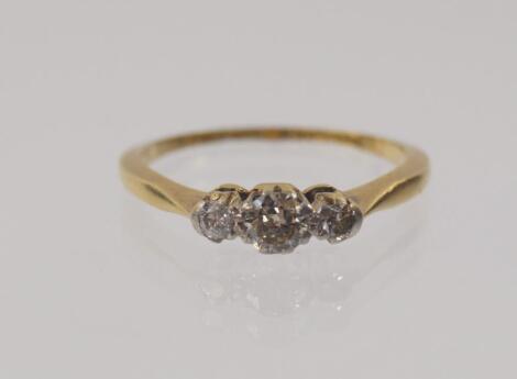 An 18ct gold three stone diamond ring