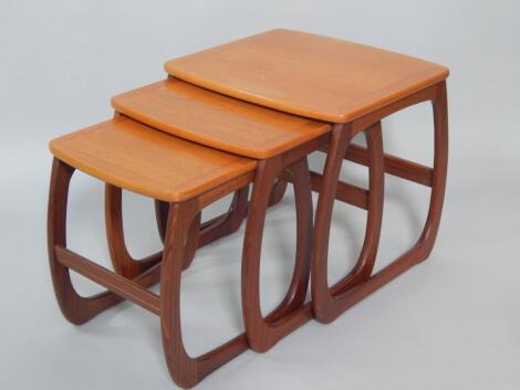 A nest of Parker Knoll cross banded teak occasional tables