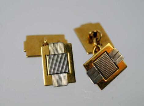 A pair of bi-coloured metal cuff links