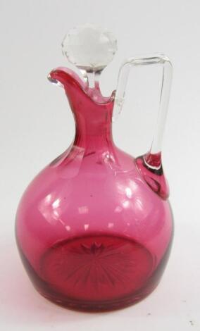 An Edwardian cranberry glass claret jug