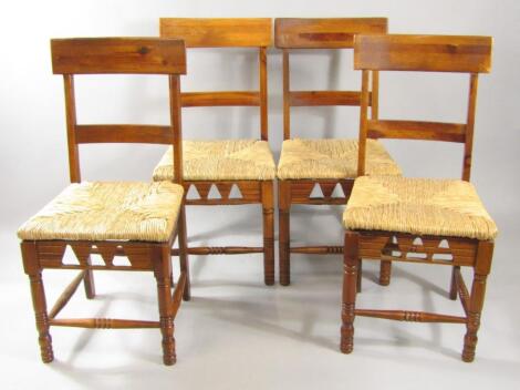 A set of four Dixy oak and rush seated single dining chairs