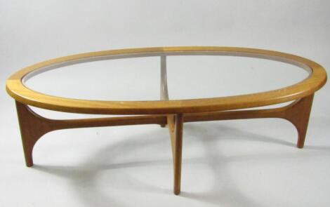 A 1970s oval teak occasional table