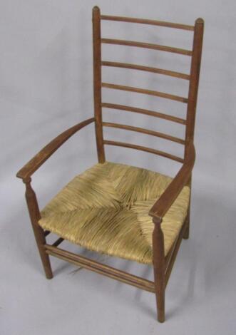 An early 20thC oak ladderback nursing chair