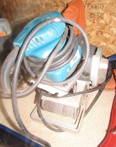 An Elu belt sander and a green electric sander