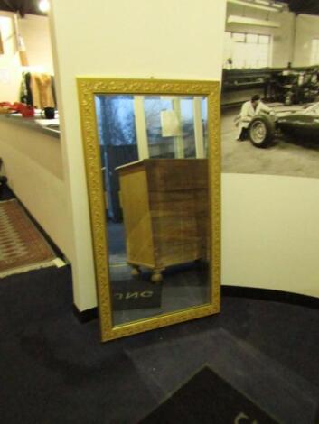 A rectangular gilt plaster wall mirror