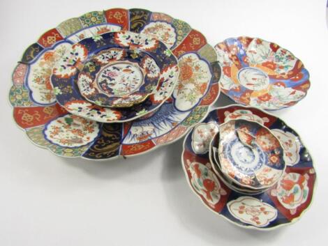 A Japanese fluted Imari dish decorated with panels of birds and flowers