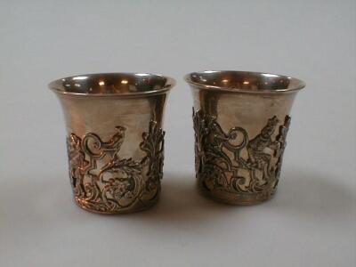 A pair of silver beakers