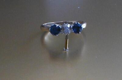 WITHDRAWN BY VENDOR PRE-SALE. A three stone diamond and sapphire set ring