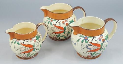 A graduated set of three Wedgwood & Co Art Deco style jugs
